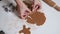 Housewife makes christmas cookies. Woman cut the shape of gingerbread in the form of a Christmas tree from raw dough