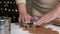 Housewife makes christmas cookies. Woman cut the shape of gingerbread in the form of a Christmas tree from raw dough