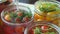 Housewife marinating cherry tomatoes with dill or fennel in jars