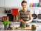 Housewife pickling cucumbers in kitchen