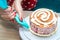 Housewife prepares sponge cake in kitchen. Close-up. Woman`s hands