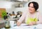 Housewife signing papers in kitchen