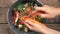 A housewife sorts organic kitchen waste into a compost bucket. Reducing Wasted Food At Home. Composting Reduce Reuse