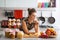 Housewife standing near jars with fruits jam