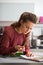 Housewife studying fresh spices herbs in kitchen