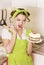 Housewife wearing in green apron cooking sweet cake