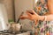 housewife woman holding a gadget smartphone or tablet to check receipt while cooking at the kitchens