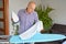 Housework and household concept - man ironing shirt on iron board at home.