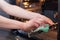 Housework and housekeeping concept. Scrubbing the stove and oven. Close up of female hand with green sponge cleaning the kitchen .