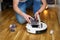 Housework and technology concept. Maintenance and service of robot vacuum cleaner. Cleaning, repair, replacement of parts. Man