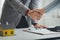 Housing estate agents shake hands with customers after a deal is completed, explaining and presenting information about homes and