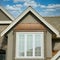 Housing Market Custom Home Copper Roof Stucco Siding Cumulus Sky Background