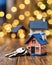 Housing market miniature house on wooden table with set of keys