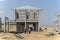 Housing property construction progress, people are building a precast house, the workman working infront the house in a hot day