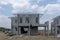 Housing property construction progress, people are building a precast house, the workman working on the stair in a hot day