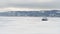 Hovercraft on the ice of lake Baikal in winter time. Clip. Aerial view of the air cushion vehicle on the thick ice of