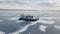 Hovercraft on the ice of lake Baikal in winter time. Clip. Aerial view of the air cushion vehicle on the thick ice of