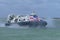 Hovercraft surrounded by sea spray entering Southsea beach from Ryde