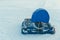 A hovercraft transport in blue protective covers stands on a frozen lake full of snow and ice. Copyspace for your text