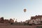 hovering hot air balloon over the mountains