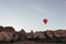 hovering hot air balloon over the mountains