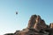 hovering hot air balloon over the mountains