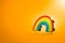 Hovering rainbow symbol  on orange background. LGBT equal rights movement and gender equality concept. Copy space on the