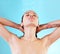 This is how I unwind after a long day. a young woman enjoying a shower against a blue background.