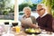 This is how we keep ourselves in the loop. an affectionate senior couple reading the newspaper while enjoying a meal