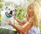 How many treats am I getting for this. a woman bathing her pet dog outside on a summers day.