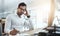 How much longer till this boring day ends. a young businessman looking bored while working in an office.