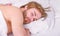 How much sleep you actually need. Man handsome guy lay in bed. Get adequate and consistent amount of sleep every night