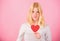 How to fight valentines day loneliness. Girl hold heart love symbol over pink background. Valentines day concept. How to