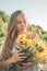 How to Harvest and Dry Herbs. Traditional medicinal plants. Woman picking flower in summer field with sunlight ray