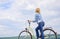 How to learn to ride bike as an adult. Woman rides bicycle sky background. Active leisure. Girl ride bicycle. Healthiest