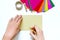 How to make a flower at home from colored paper. Hands make a colorful flower out of paper, scissors and pencil. Step 2