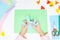 How to make paper bunny for Easter greetings and fun. Children art project. DIY concept. Kids hands makes paper craf. Step by step