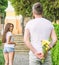 How to pick up girl. Girl looks at man with bouquet with interest. Start dating. Golden rules for asking women out