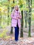 How to rock puffer jacket like a star. Puffer fashion concept. Girl fashionable blonde walk in autumn forest. Woman wear