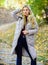 How to rock puffer jacket like star. Puffer fashion trend concept. Girl fashionable blonde walk in autumn park. Woman