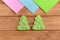 How to sew Christmas decoration. Step. Green felt Christmas tree decorated with pink and blue circles on a wooden background