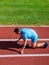 How to start running. Running tips for beginners. Man athlete stand low start position at stadium path. Beginning of new