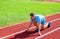 How to start running. Sport tips from professional runner. Man athlete runner stand low start position stadium path