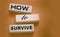 How to Survive words on wooden blocks. Surviving in wild nature concept. Desease and epidemy survival healthcare