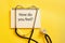 How are you feeling? Medical question on paper. Yellow medical background with statoscope