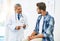 How are you feeling today. a confident mature male doctor consulting with a patient inside of his office during the day.