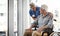 How are you feeling today. a mature female nurse and her senior male wheelchair-bound patient in the hospital.