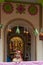 Howrah,India -October 26th,2020 : Bengali girl child posing with Goddess Durga in background, inside old age decorated home. Durga