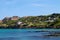 Howth Dublin beach view with the clean sea and forested, green mountains, blue sky background