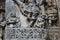 Hoysaleswara Temple wall carved with sculpture of Garuda humanoid bird in praying posture